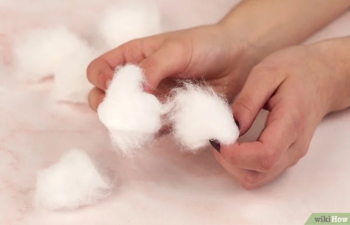 Tear five cotton balls in half.