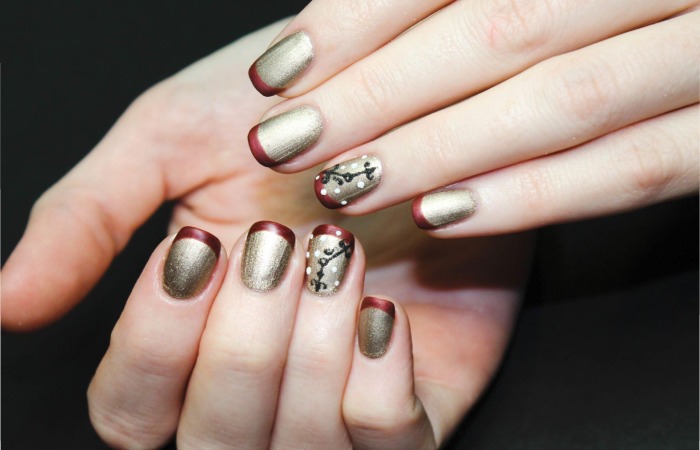 https___www.istockphoto.com_photo_gold-manicure-with-a-voluminous-white-design-and-a-maroon-french-on-delicate-female-gm1215095621-353787444_phrase=The+Latest+Vogue+Nail
